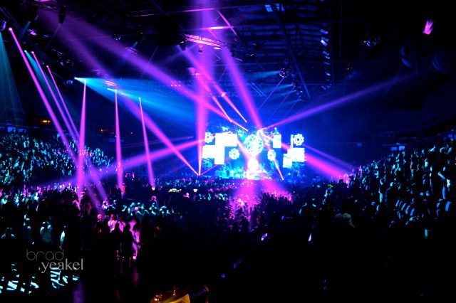 Concert with vibrant pink and blue lights.