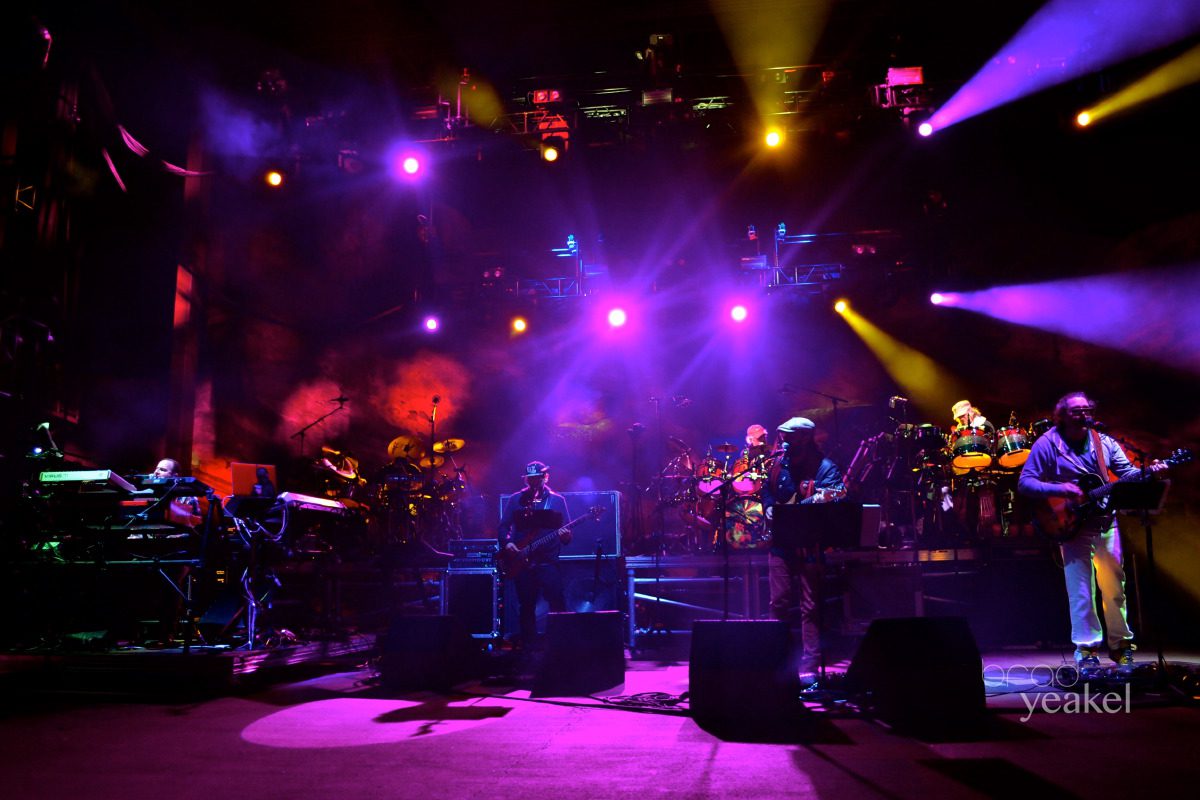 Band performing on stage with colorful lights.