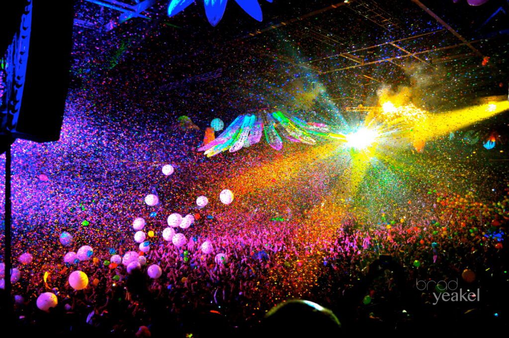 Colorful concert with lights and confetti.