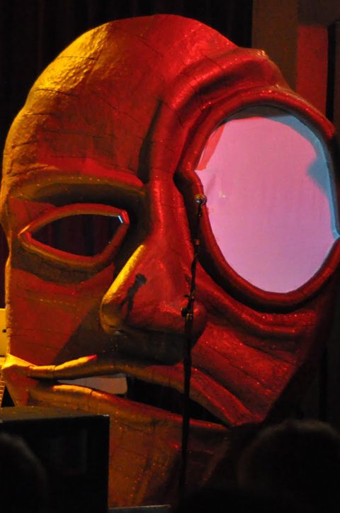 Large, colorful abstract face sculpture with lighting.