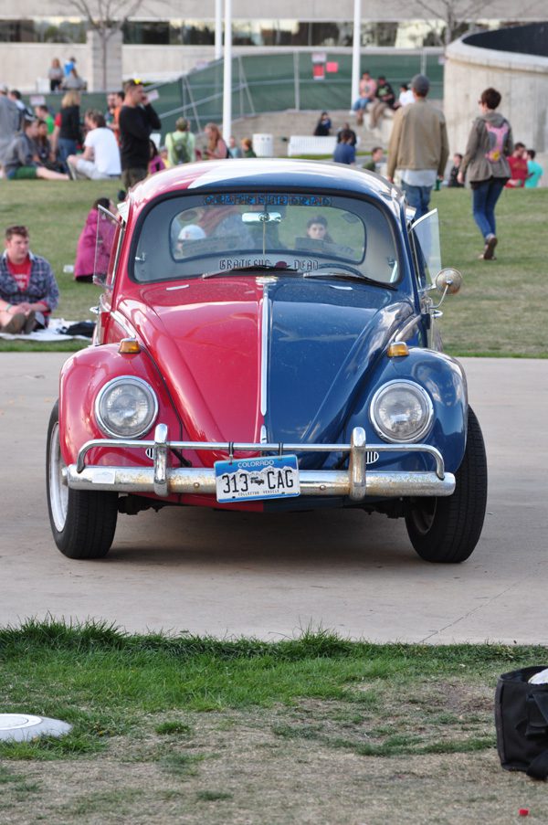 Red and blue vintage car parked outside.