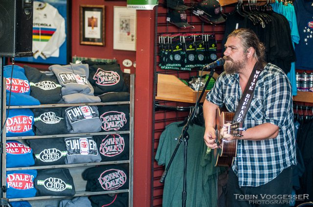 Musician performing in a store with merchandise.