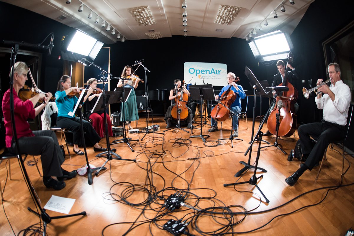 Musicians performing in a recording studio ensemble.