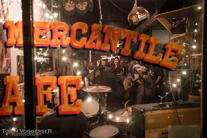 Band performing inside a lively cafe.