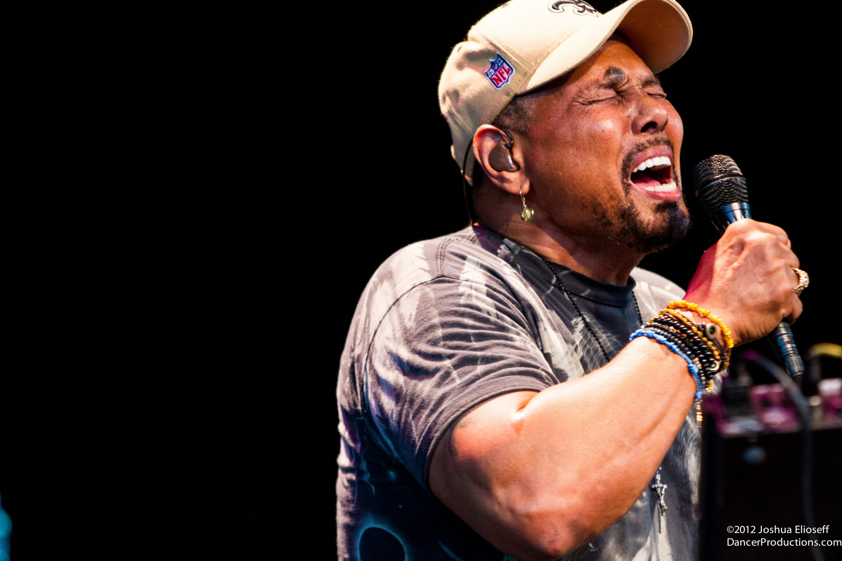 Singer passionately performing on stage with microphone.