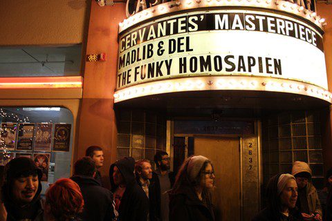 Crowd outside venue with marquee sign.
