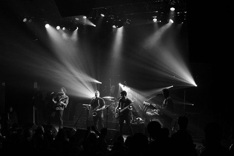 Band performing live on stage, black-and-white.