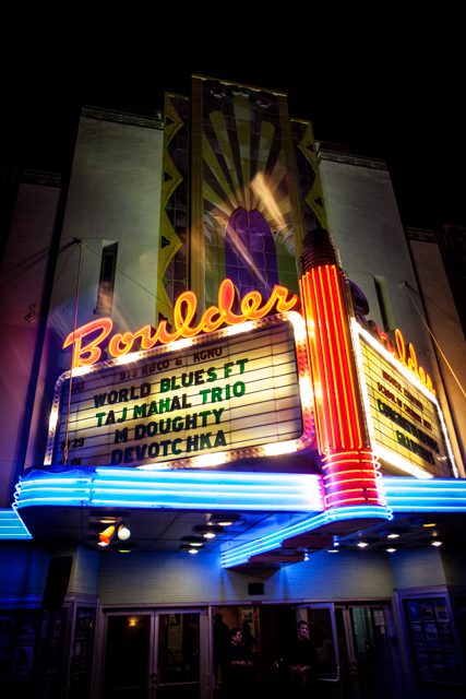 Neon-lit Boulder theater marquee at night.
