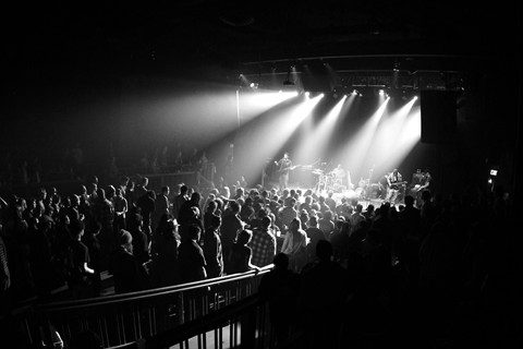 Concert crowd in black and white lighting.