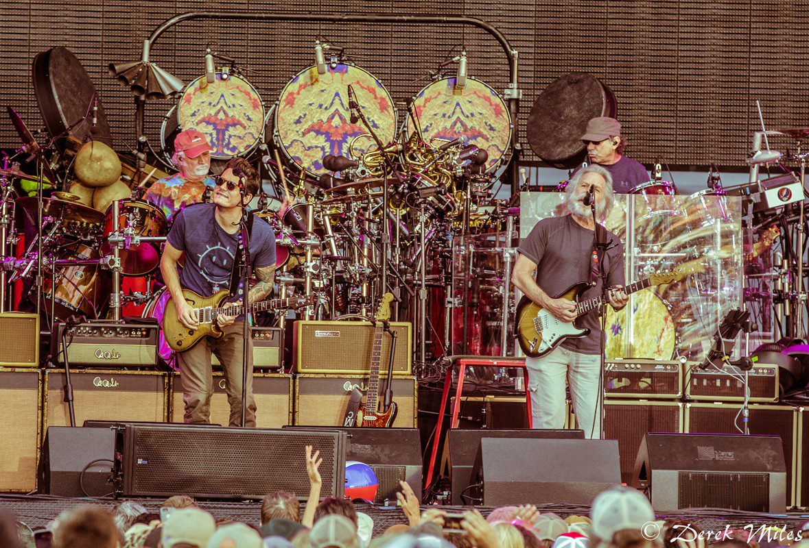 Band performing live on stage with guitars.