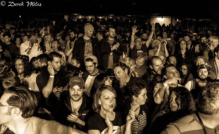 Crowd enjoying a concert in sepia tone.