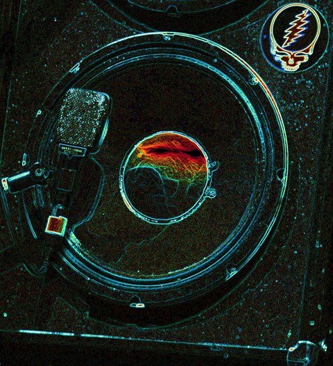 Psychedelic speaker with microphone and colorful design.