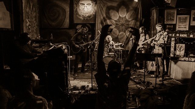 Live band performing on dimly lit stage.