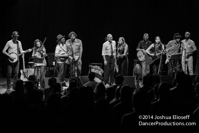 Band performing on stage in black and white.