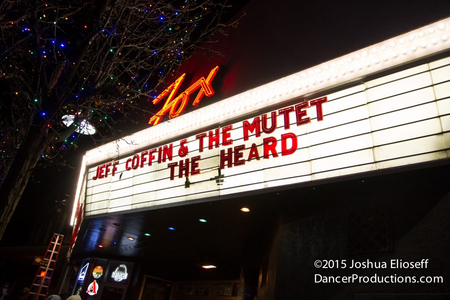 Concert marquee at night with colorful lights.