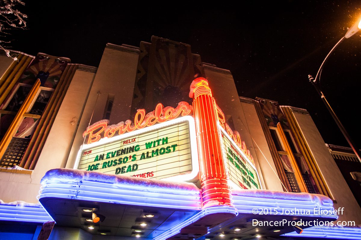 Historic theater marquee with neon lights at night.