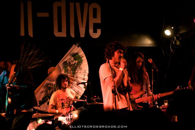 Band performing live on dimly lit stage.