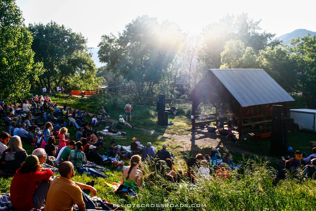 Outdoor concert with audience in a park.