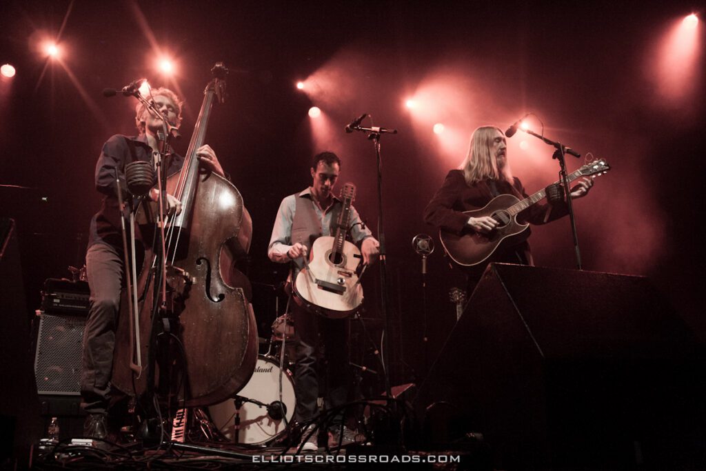 Musicians performing on stage with instruments.