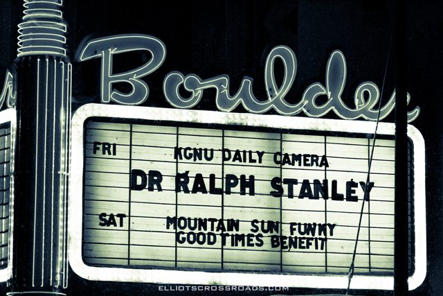 Marquee sign with event listings at night.
