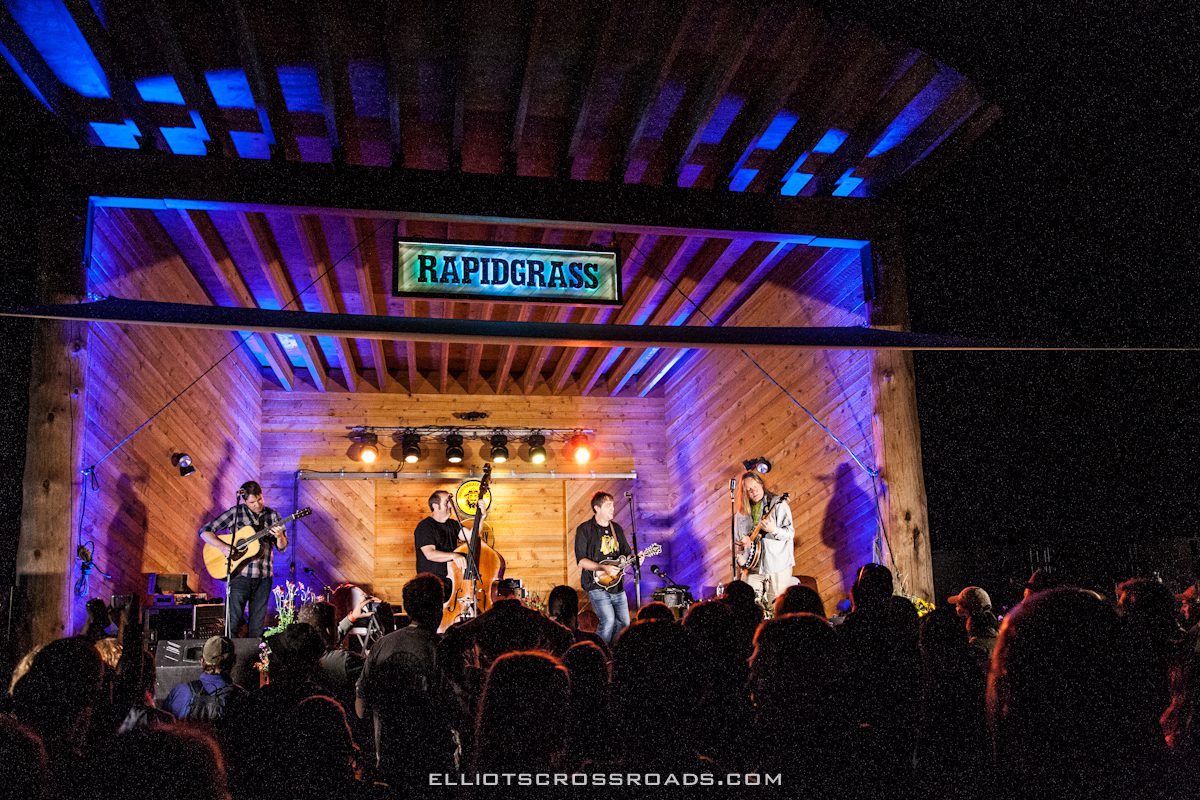Band performing on stage at night concert.