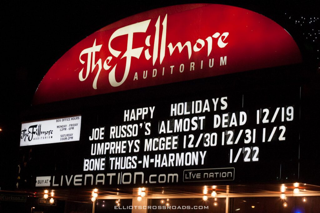 Fillmore Auditorium concert schedule marquee at night.