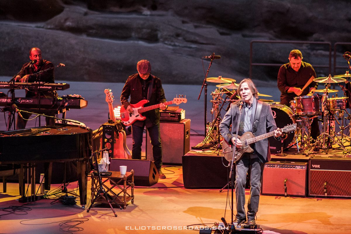 Band performing live on stage with instruments.