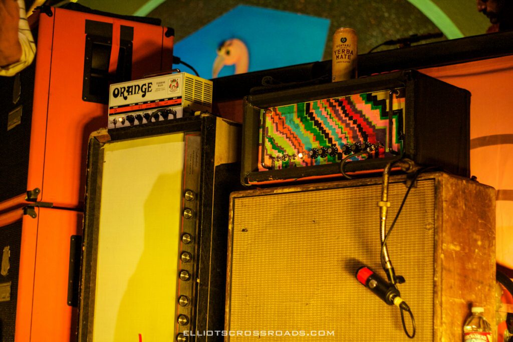Colorful guitar amplifiers with microphone on stage.