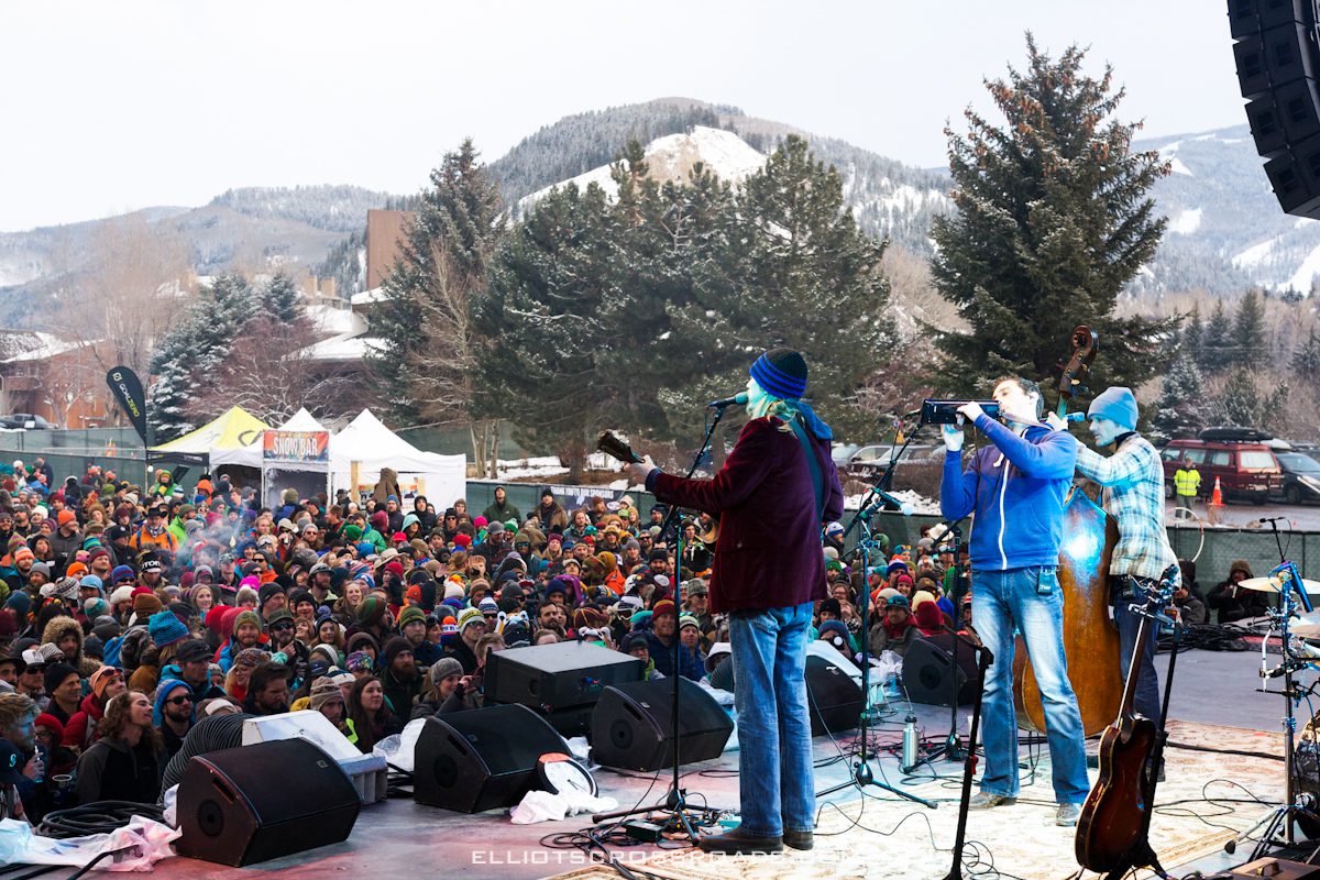 Outdoor concert with band performing to crowd.
