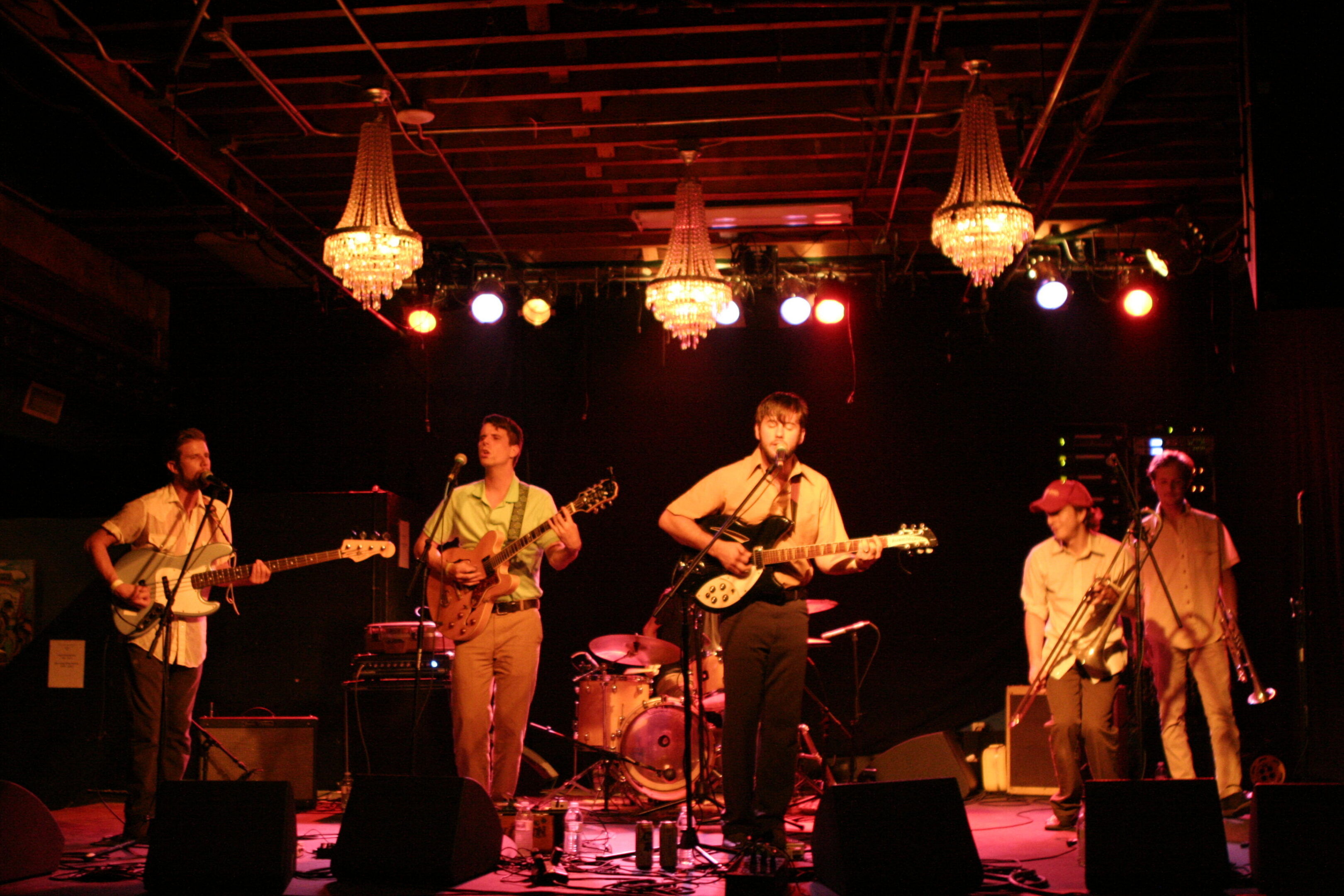Band performing on stage with instruments.