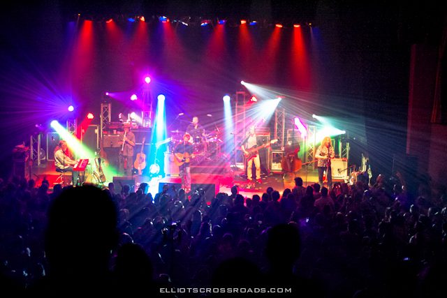 Live band performing on colorful stage.
