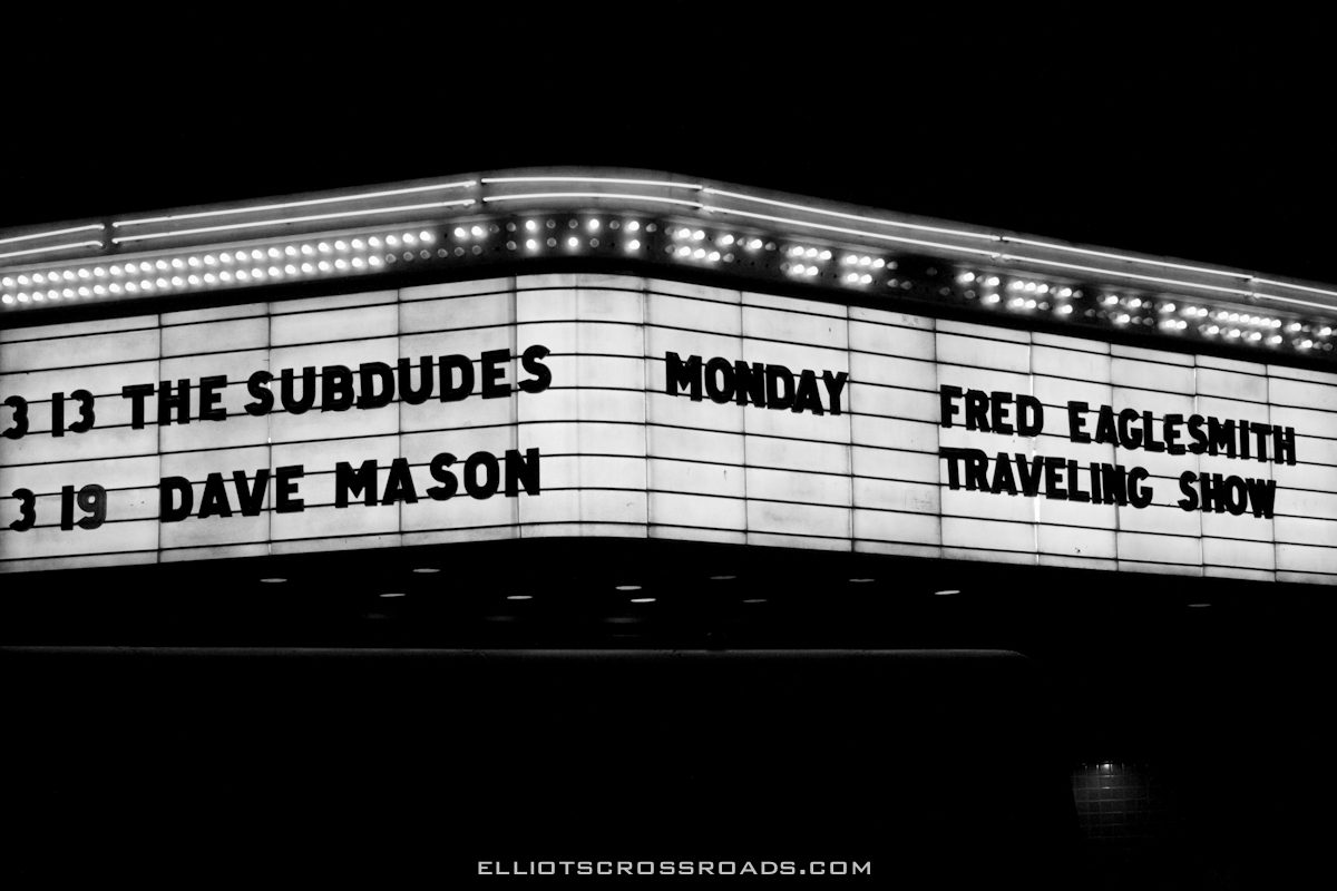 Theater marquee with upcoming concert dates listed.