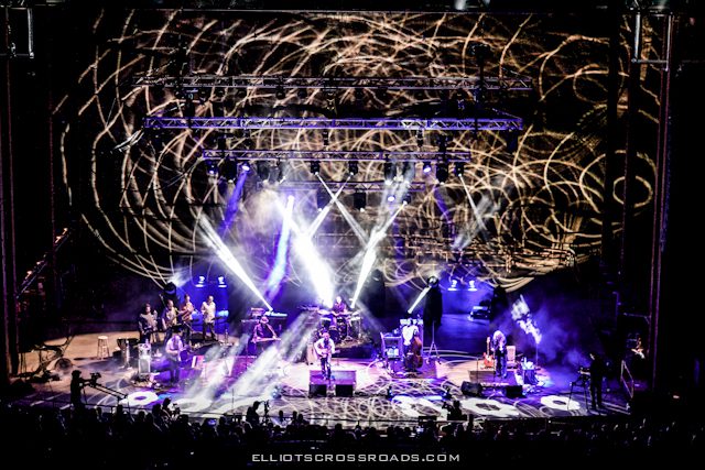 Concert stage with vibrant light show.