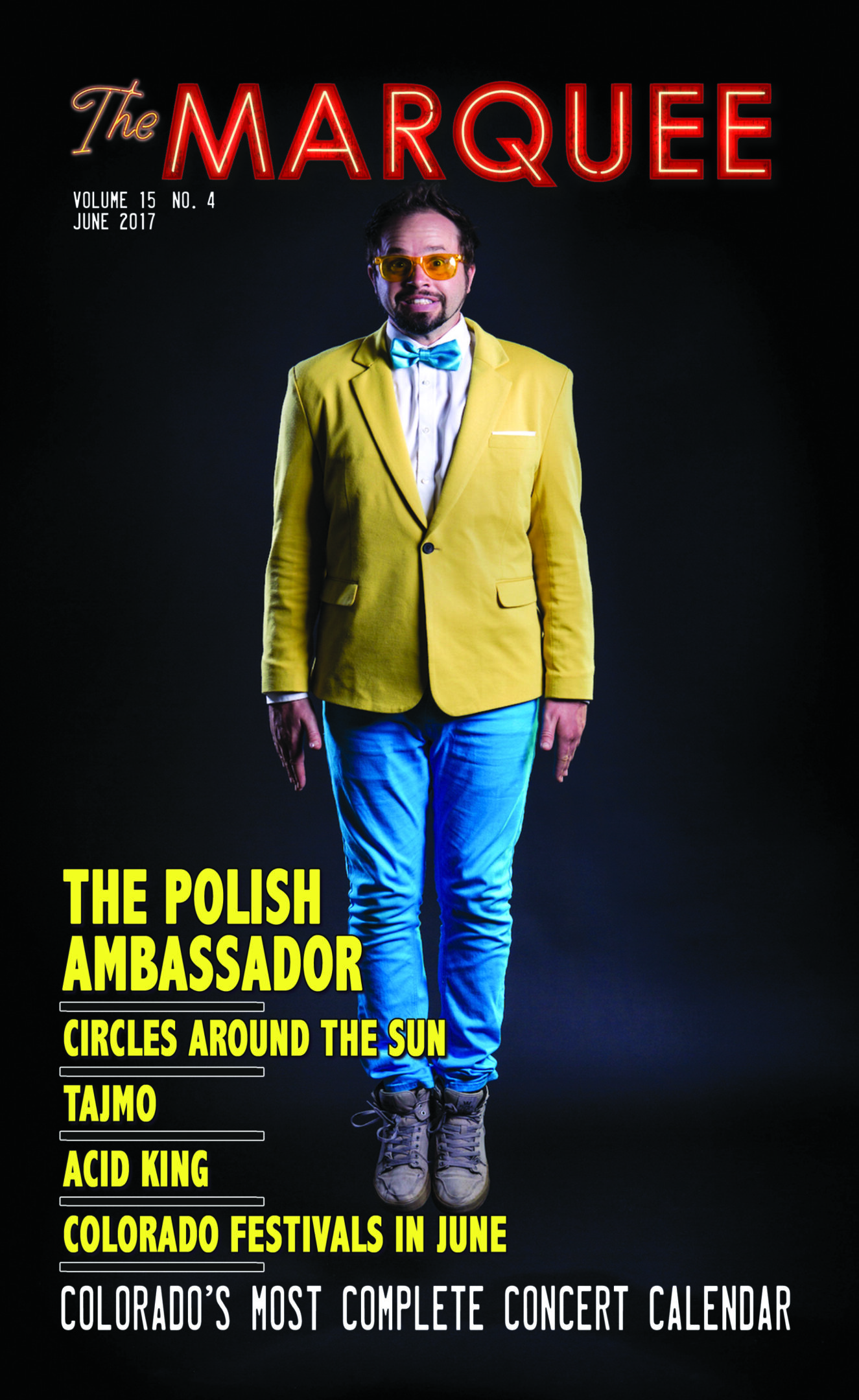 Man in vibrant outfit on magazine cover.