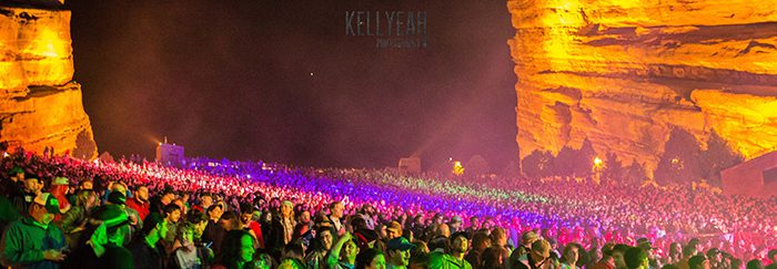 Concert crowd at Red Rocks Amphitheatre, illuminated.