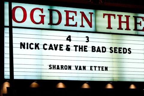 Theater marquee featuring Nick Cave concert announcement.