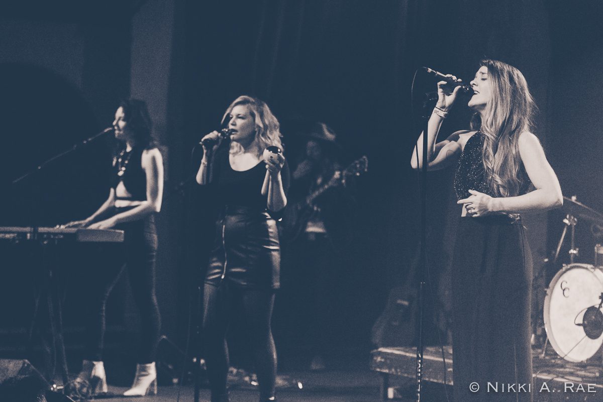 Live band performing on stage in monochrome.
