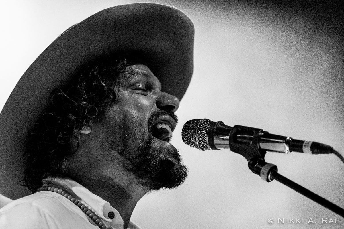Singer performing passionately with a microphone.