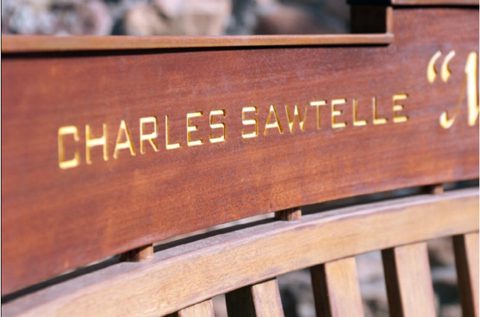 Wooden bench with "Charles Sawtelle" engraved text.