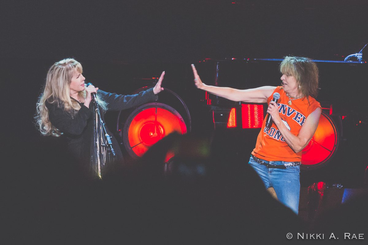 Two performers singing and gesturing on stage.
