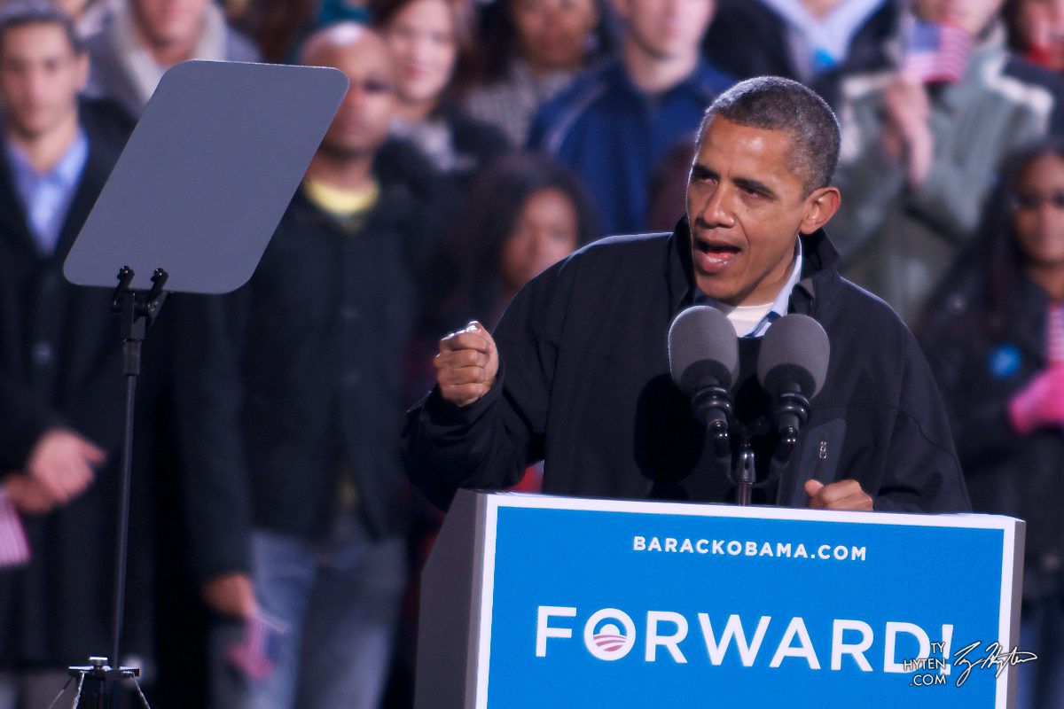 Man speaking at podium during public event.