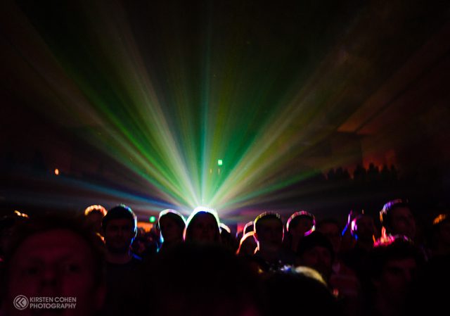 Concert crowd with colorful stage lights.