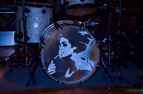 Drum set with a painted portrait.
