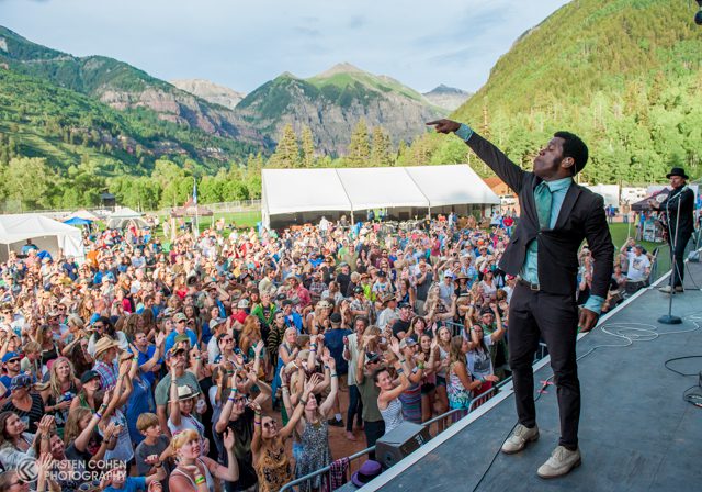 Outdoor concert with enthusiastic crowd and performer.
