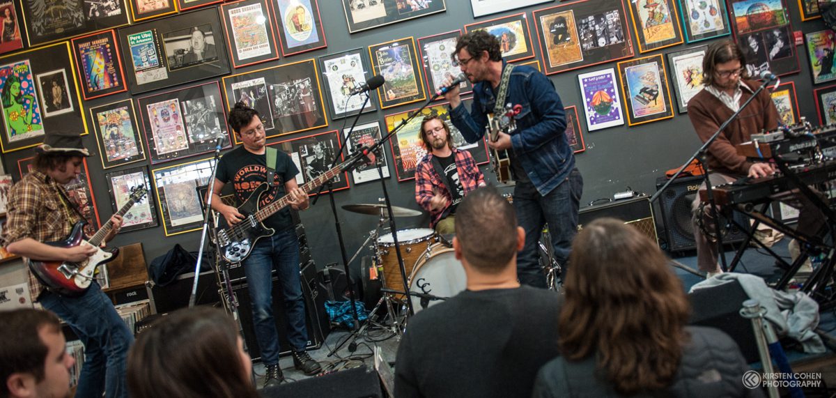 Band performing live in front of audience.