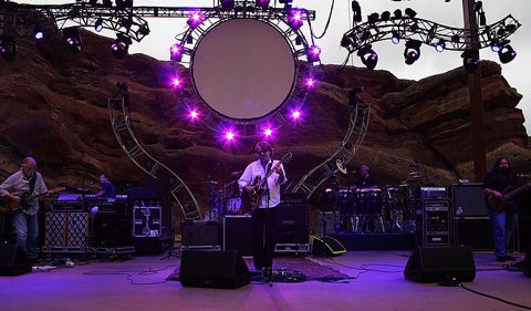 Band performing on stage with purple lights.