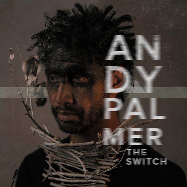 Man with face paint and twig necklace.