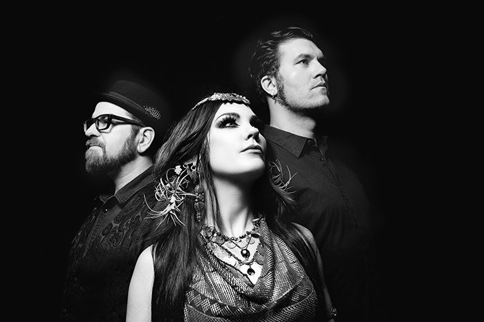 Three people posing in artistic black-and-white.