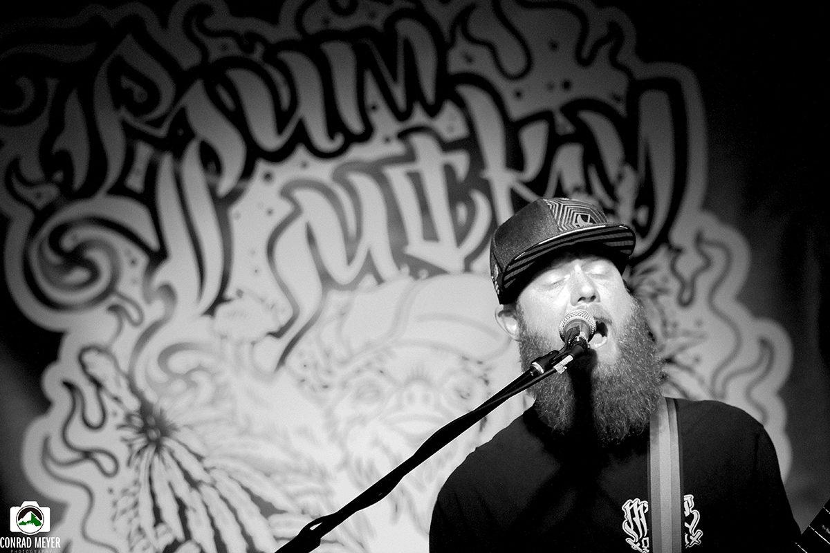 Singer performing with graffiti backdrop.