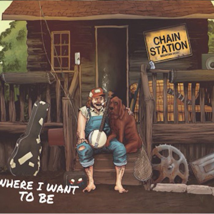 Man with banjo and dog on porch.